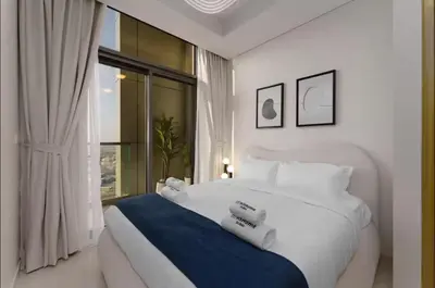 a bedroom with a large white bed and a window at Aykon Luxury Sky Collection Suites with Balcony & Sea View by HSHOME in Dubai