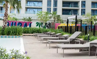 a row of lounge chairs in front of a building at Aykon Luxury Sky Collection Suites with Balcony & Sea View by HSHOME in Dubai