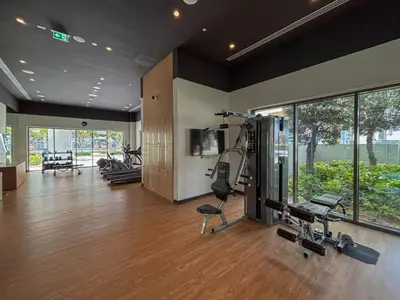 a gym with several treadmills and machines in a room at Frank Porter - Bayshore at Creek Beach in Dubai