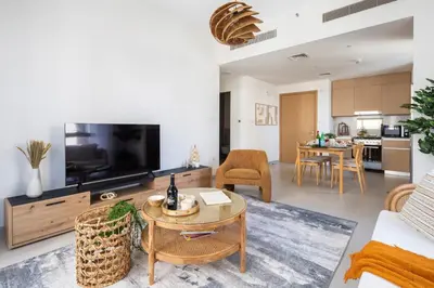 a living room with a couch and a tv and a table at Frank Porter - Bayshore at Creek Beach in Dubai