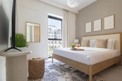 a bedroom with a large bed and a large window at Frank Porter - Bayshore at Creek Beach in Dubai