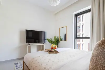a bedroom with a bed with a tv and a window at Frank Porter - Bayshore at Creek Beach in Dubai