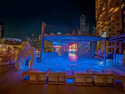 a pool on the roof of a building at night at Frank Porter - Emaar Residences Dubai Marina in Dubai