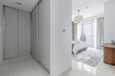 a white room with white walls and sliding doors at 2BR Beachfront Gem with Dazzling Views of the Palm in Dubai