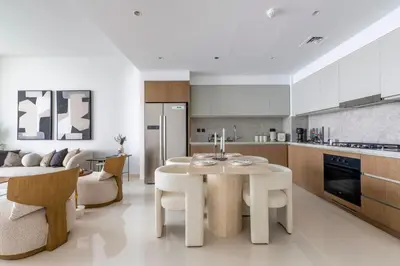 a kitchen and living room with a table and chairs at 2BR Beachfront Gem with Dazzling Views of the Palm in Dubai