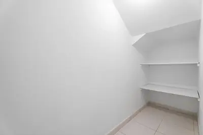 a white kitchen with a white shelf and white floor at Whole 3 BR with Maids Room House - The Springs - Privat Garden in Dubai