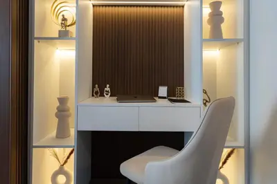 a white desk with a chair and a laptop at Dubaiashome - Luxury Special Stay in Dubai
