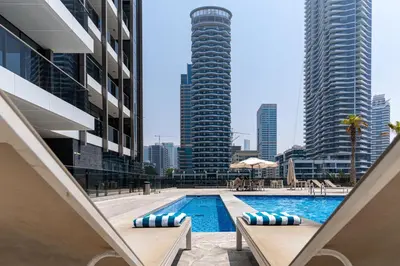 a swimming pool in the middle of a city with tall buildings at Dubaiashome - Luxury Special Stay in Dubai