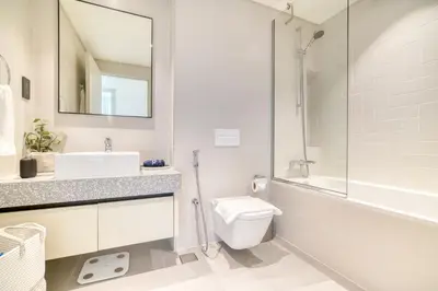 a bathroom with a sink and a toilet and a shower at Marina Vista 1BR Sea View Luxury Escape in Dubai