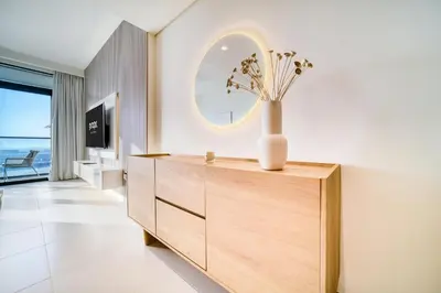 a vase on a dresser in a room with a mirror at Marina Vista 1BR Sea View Luxury Escape in Dubai