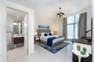 a hotel room with a bed and a bathroom at Marco Polo - Modern 1BR in Business Bay near Burj Khalifa in Dubai