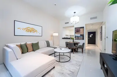 a white living room with a couch and a table at Marco Polo - Modern 1BR in Business Bay near Burj Khalifa in Dubai