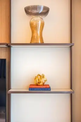 a shelf with two books and a vase on it at Address Dubai Opera Residences in Dubai