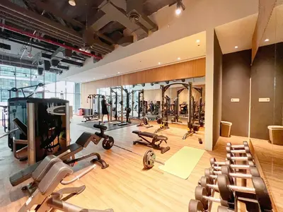 a gym with lots of treadmills and exercise equipment at The Smart Concierge - Seven Palm in Dubai