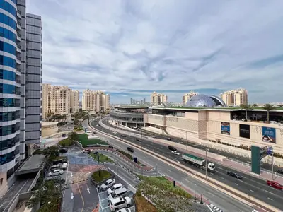 a city with buildings and cars on a highway at The Smart Concierge - Seven Palm in Dubai