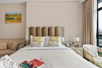 a bedroom with a large bed and a couch at The Smart Concierge - Seven Palm in Dubai