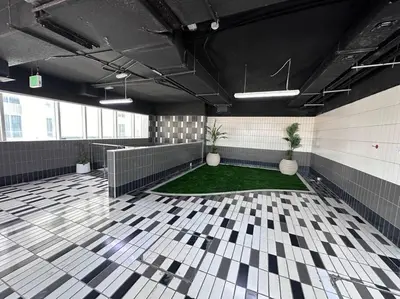 a large room with a floor with plants in it at Cozy 2 Bedroom Retreat in Dubai
