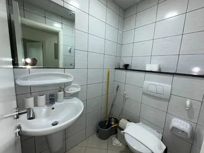 a bathroom with a sink and a toilet and a mirror at Cozy 2 Bedroom Retreat in Dubai
