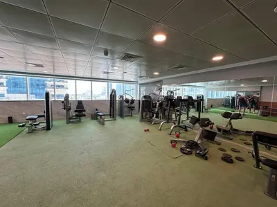 a gym with lots of equipment in a building at Cozy 2 Bedroom Retreat in Dubai
