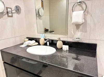 a bathroom with a sink and a mirror at Ghalia Studio Apartment in Dubai
