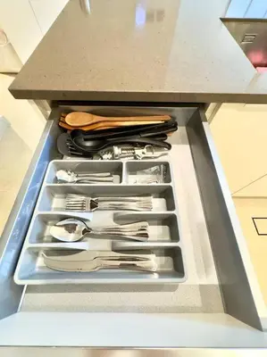 a drawer filled with utensils in a refrigerator at Dubai Marina Gate 1 Deluxe in Dubai