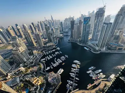 an aerial view of a city with boats in a harbor at Dubai Marina Gate 1 Deluxe in Dubai