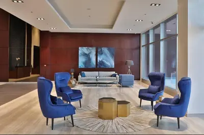 a lobby with blue chairs and a couch at Dubai Marina Gate 1 Deluxe in Dubai
