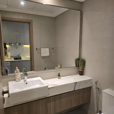 a bathroom with a sink and a mirror at VESTA - Dubai Residence in Dubai