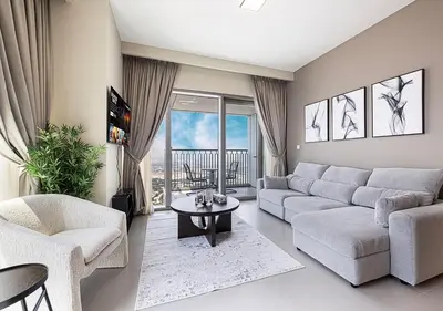 a living room with a couch and a table at Luxury 2 BR Apartment, 5 Mins to Dubai Mall with Amazing view in DownTown Views 2 in Dubai