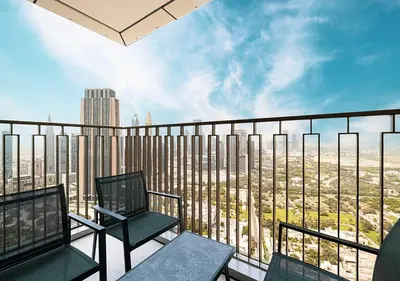 a balcony with two chairs and a view of a city at Luxury 2 BR Apartment, 5 Mins to Dubai Mall with Amazing view in DownTown Views 2 in Dubai