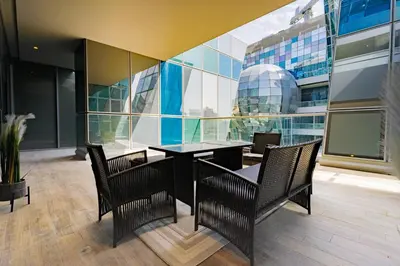 a dining room with a table and chairs in a building at Escape24 2BR Huge Terrace with Canal View in Dubai