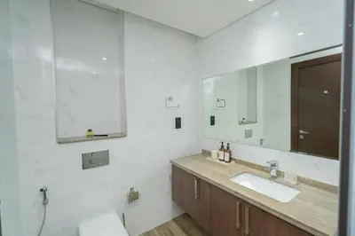 a bathroom with a sink and a mirror at Escape24 2BR Huge Terrace with Canal View in Dubai