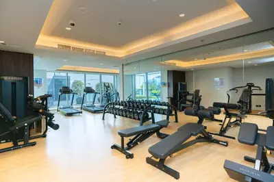 a gym with a lot of treadmills and exercise equipment at Escape24 2BR Huge Terrace with Canal View in Dubai