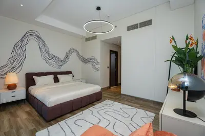 a bedroom with a large bed and a rug at Escape24 2BR Huge Terrace with Canal View in Dubai