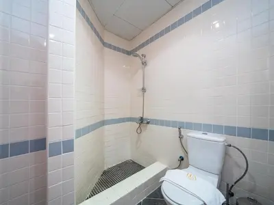 a bathroom with a toilet and a shower at Spacious 2 Bedroom Apartment in Tecom in Dubai