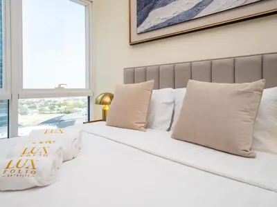 two beds with white pillows in a bedroom at Spacious 2 Bedroom Apartment in Tecom in Dubai