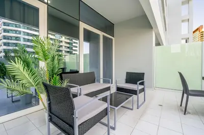 a patio with chairs and a table on a building at GuestReady - Modern living at Reva Residence in Dubai