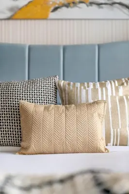 a white couch with pillows on it with a wall at GuestReady - Modern living at Reva Residence in Dubai