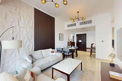 a living room with a white couch and a table at Silverene Tower B - Exciting Two Bedroom in Dubai