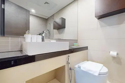 a bathroom with a sink and a toilet at Silverene Tower B - Exciting Two Bedroom in Dubai