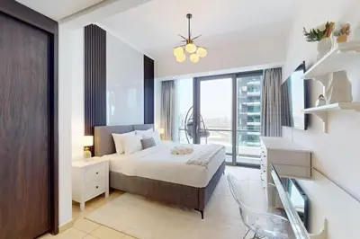 a bedroom with a bed and a large window at Silverene Tower B - Exciting Two Bedroom in Dubai