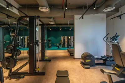 a gym with several treadmills and cardio machines at GuestReady - Luxurious living with sea view in Dubai