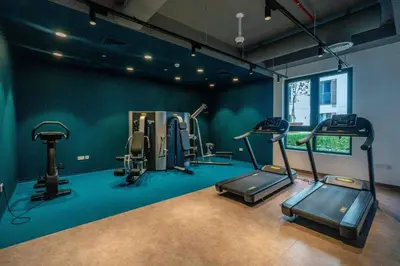 a gym with several tread machines in a room at GuestReady - Luxurious living with sea view in Dubai