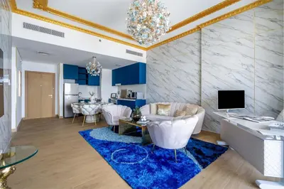 a living room with a white couch and a blue rug at GuestReady - Luxurious living with sea view in Dubai