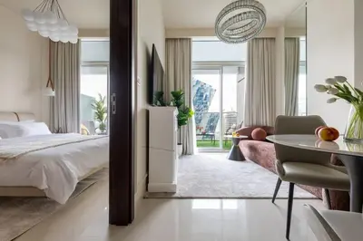a bedroom with a bed and a table and a couch at Glamorous 1Bedroom in Business bay l Large Balcony in Dubai