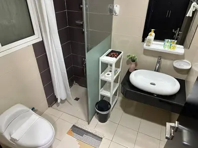 a bathroom with a toilet and a sink and a shower at Cozy Studio- Dubai Marina in Dubai