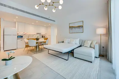 a living room with a couch and a table at Luxe 1BD apartment in La Vie with beach access in Dubai