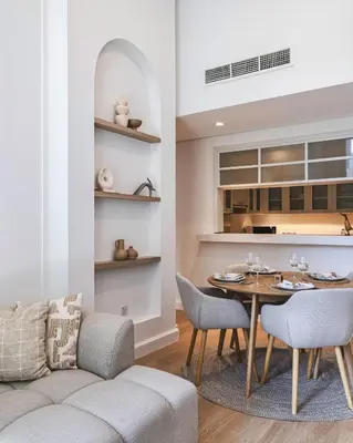 a living room with a table and a couch at Downtown Oasis Luxury One-bed in Downtown Dubai in Dubai