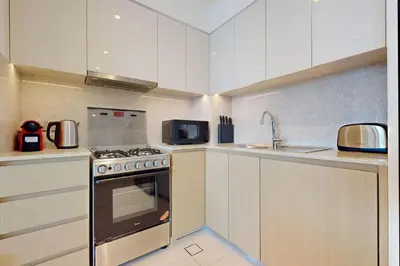 a kitchen with a stove and a microwave at Burj Royale - Central Two Bedroom in Dubai