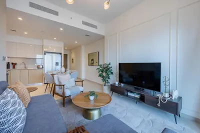 a living room with a large flat screen tv at Burj Royale - Central Two Bedroom in Dubai